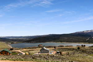 Property view of mountains featuring a water view