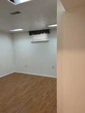 Unfurnished room with hardwood / wood-style floors