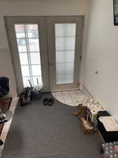 Doorway to outside featuring french doors and light tile flooring