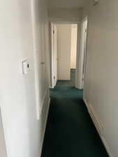 Hallway with dark carpet