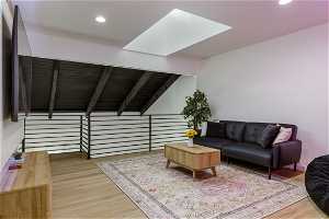 Living room featuring beamed ceiling and hardwood / wood-style floors