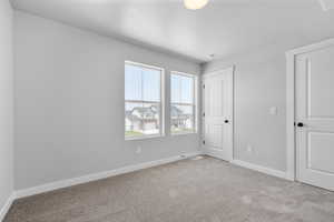 Empty room with light colored carpet