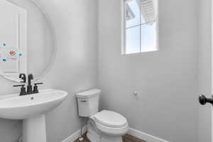 Bathroom featuring hardwood / wood-style flooring and toilet