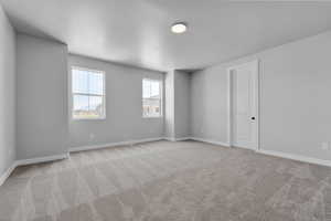 Unfurnished room with light carpet