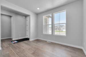 Unfurnished room with light wood-type flooring