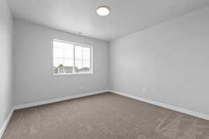 Unfurnished room with carpet