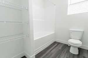 Bathroom with toilet and hardwood / wood-style floors