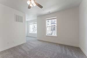 Unfurnished room with a textured ceiling, carpet flooring, and ceiling fan