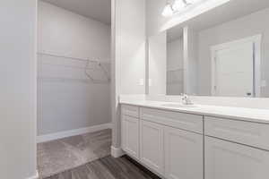 Bathroom featuring vanity and hardwood / wood-style floors