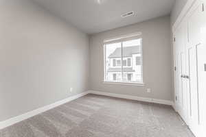 Unfurnished room with carpet floors