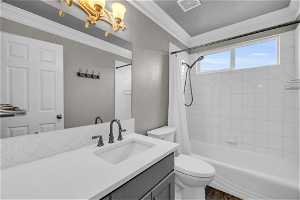 Full bathroom featuring crown molding, toilet, vanity with extensive cabinet space, shower / bath combo with shower curtain, and hardwood / wood-style flooring
