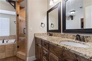 Bathroom with plus walk in shower, tile flooring, and double sink vanity
