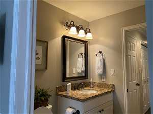 Bathroom with a textured ceiling and large vanity