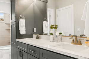 Bathroom featuring double vanity and toilet