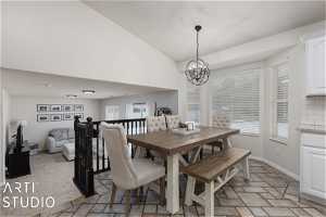 Dining space featuring plenty of natural light, a notable chandelier, and light tile flooring