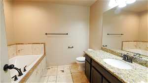 Primary Bathroom with oversized vanity, tile floors, toilet, and separate shower and tub