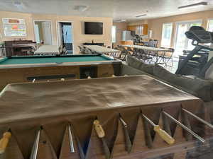 Interior space with billiards and a textured ceiling