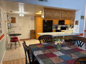 Dining room featuring sink, light tile floors, and a textured ceiling