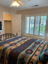 Bedroom featuring a closet, a textured ceiling, and ceiling fan