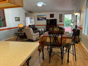 Dining room with ceiling fan and light wood-type flooring