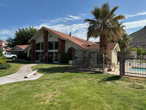 Exterior space with a fenced in pool, a patio area, and a front lawn