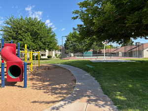 Surrounding community with a yard and a playground