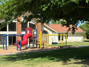 View of jungle gym with a lawn