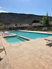 View of outdoor pool featuring a mountain view and a patio area