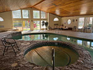 View of swimming pool with an indoor in ground hot tub