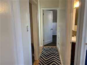 Corridor with sink and carpet