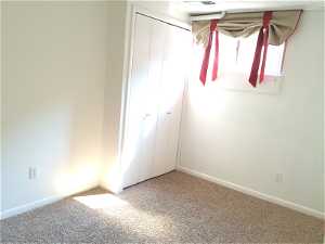 Unfurnished bedroom with a closet and carpet flooring