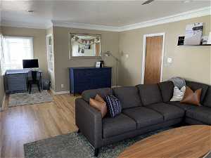 Living room featuring hardwood / wood-style floors and ornamental molding