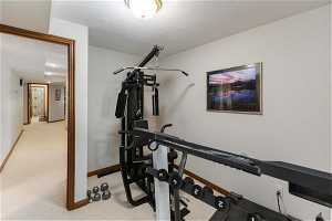 Exercise room with a textured ceiling and carpet