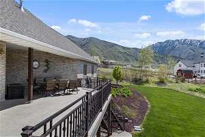 Exterior space featuring a mountain view, a patio, and a lawn