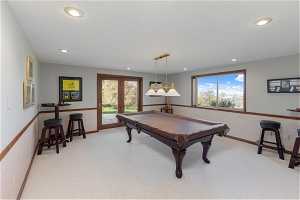 Rec room featuring french doors, pool table, and carpet flooring
