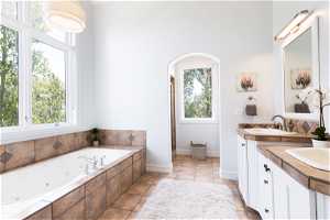 Primary bathroom with dual sinks, tile floors, and oversized vanity