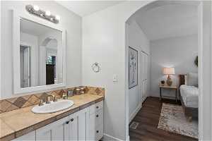 Bathroom 5 featuring backsplash, vanity, and hardwood / wood-style floors