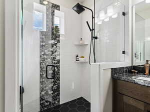 Bathroom featuring walk in shower and vanity