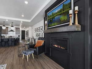 Living room featuring hardwood / wood-style flooring and a tray ceiling