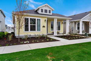 Bungalow-style house with a front yard and a porch