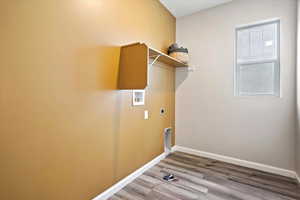 Laundry room with hookup for a washing machine, electric dryer hookup, and hardwood / wood-style floors