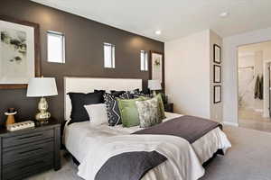 Carpeted bedroom featuring connected bathroom