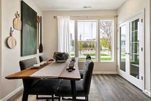 Dining space with french doors and hardwood / wood-style floors