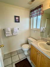 Bathroom with vanity, tile floors, and toilet