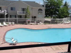 Pool featuring a patio and fence