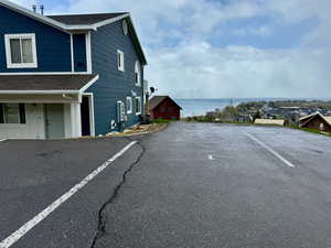 View of parking with a water view