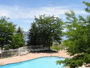 Pool with a patio and fence