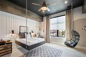 Carpeted bedroom featuring ceiling fan suspended bed and swing and a textured ceiling