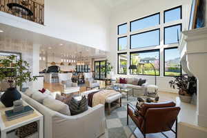 Living room featuring hardwood / wood-style flooring and a high ceiling