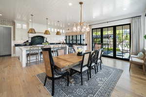 Dining area featuring wooden ceiling, a notable chandelier, and light hardwood / wood-style floors